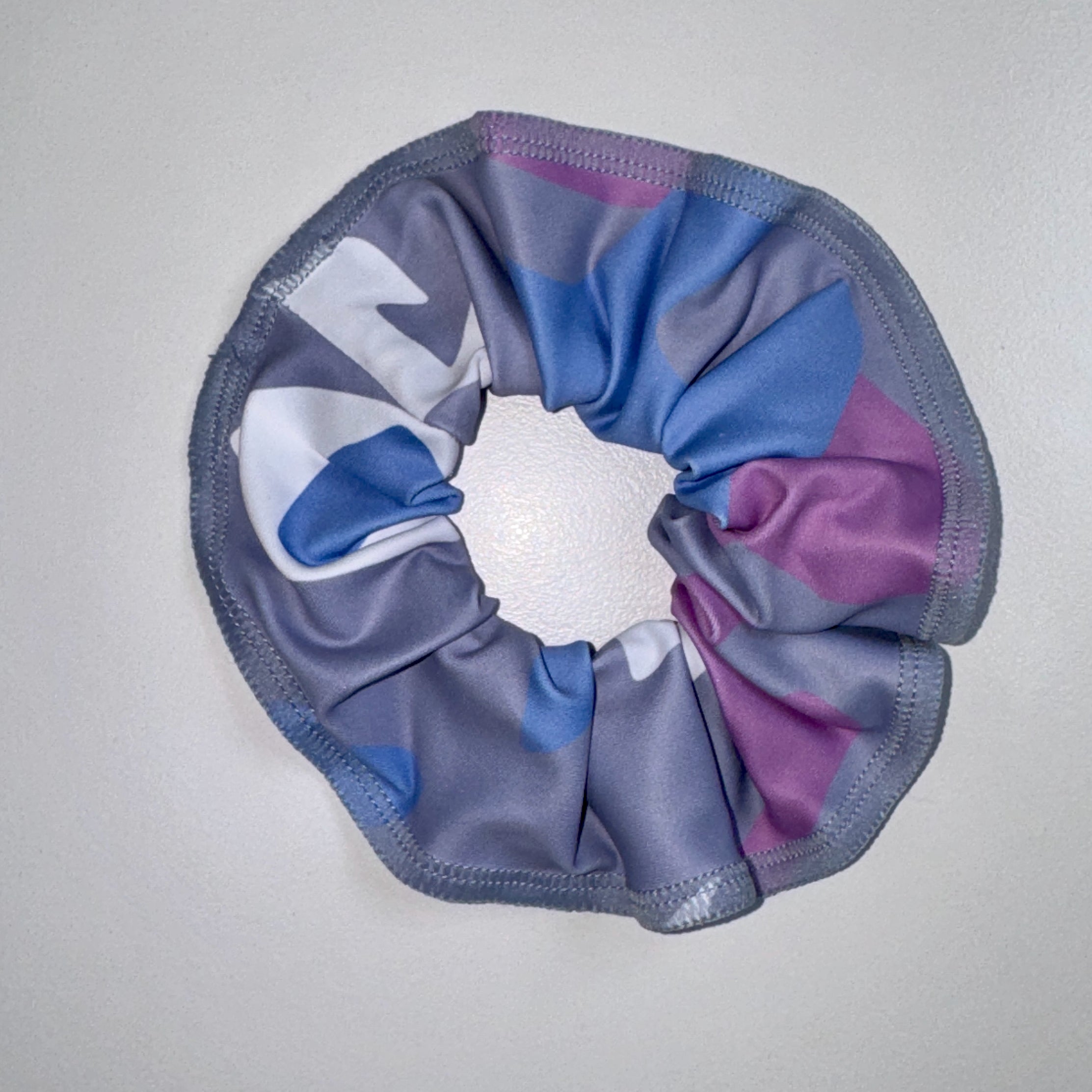 Multicolored scrunchie on a light gray background
